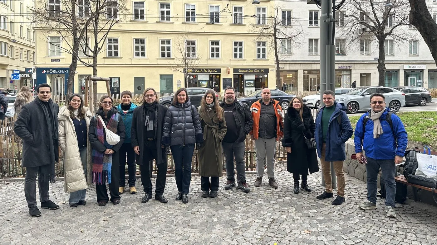 The X-VET partners standing together outdoors in Vienna in winter