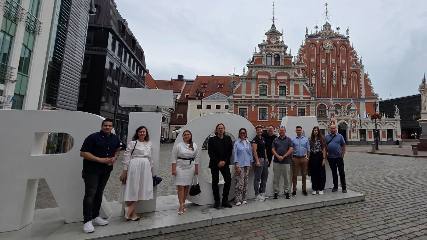 The X-VET partners next to the large RIGA letters in front of the House of the Blackheads in Riga