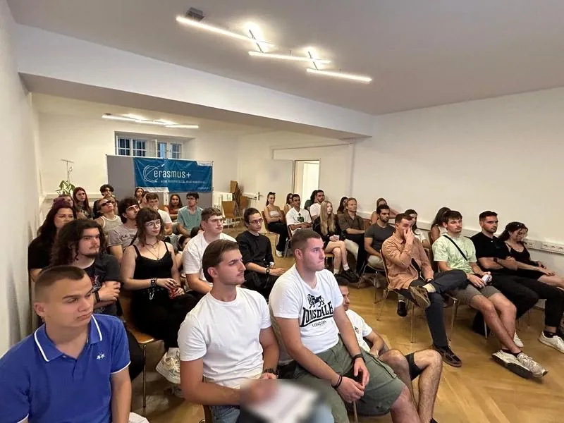The participants in a full room in Vienna, with an Erasmus+ banner at the back