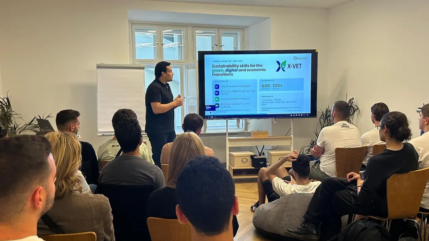 A presentation of the X-VET project to a full room of young participants in Vienna, with the X-VET slide on a large screen