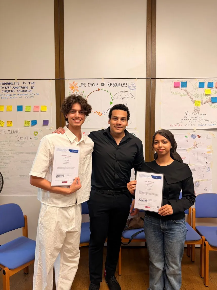 Participants holding their certificates after a workshop
