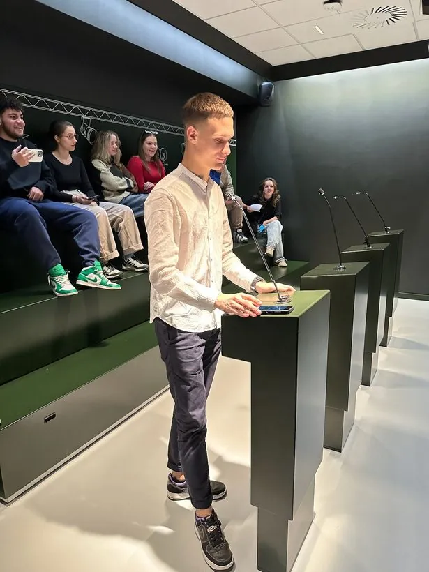 A student speaking at a lectern