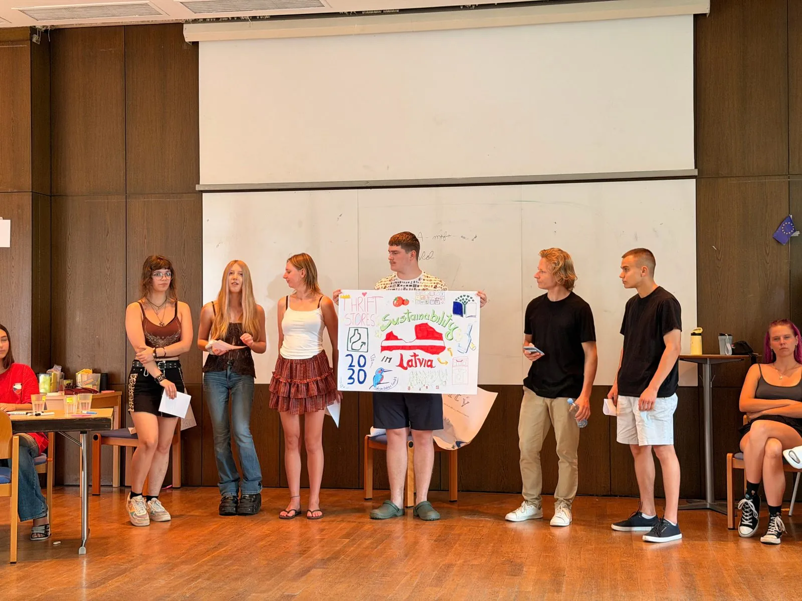 A group presenting their poster